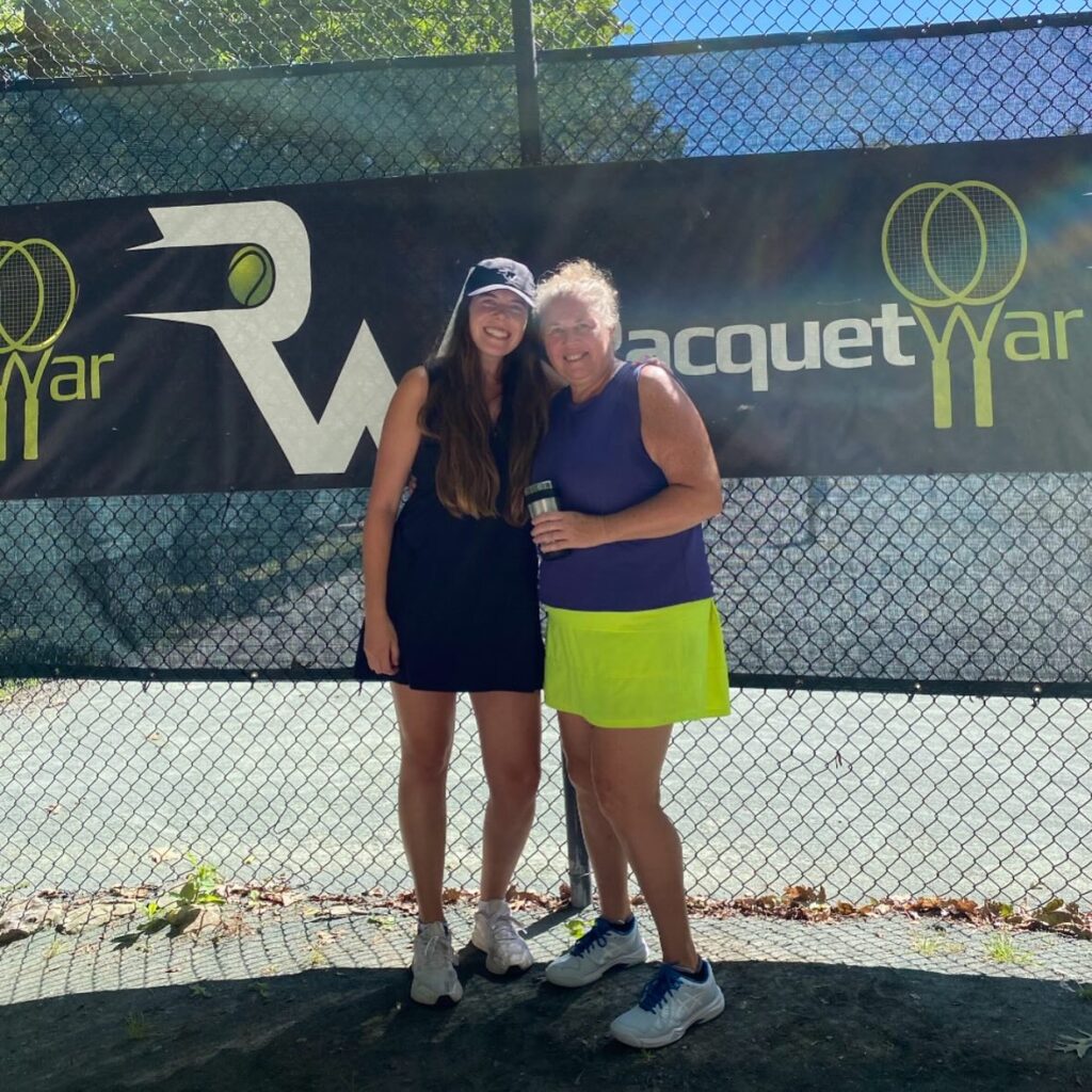 Mother and daughter playing in tennis tournament. 