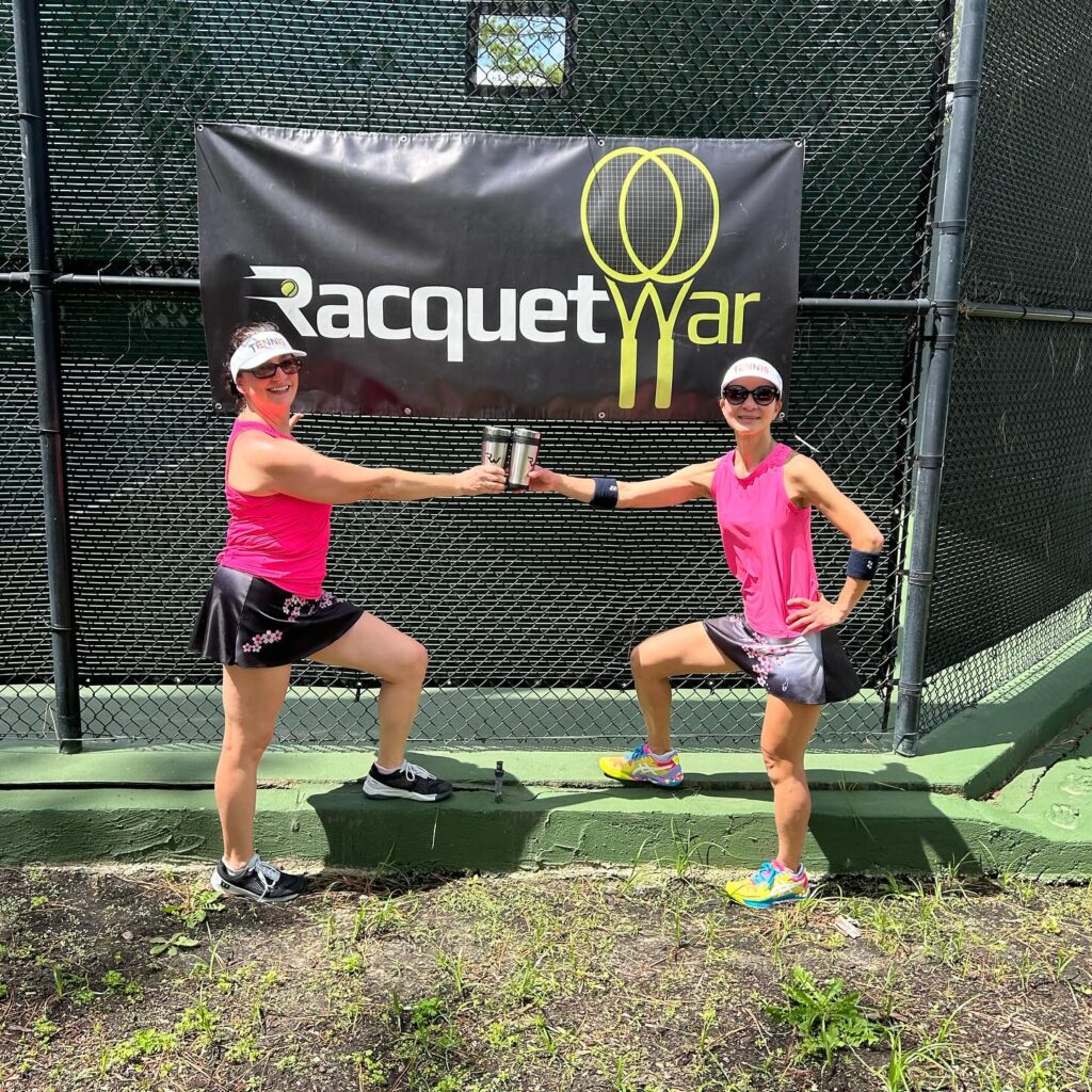 Womens tennis doubles team showing off second place trophy. 