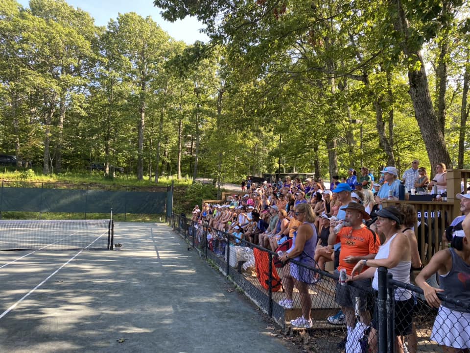 Players watching Wintergreen, VA tennis tournament at center court. 
